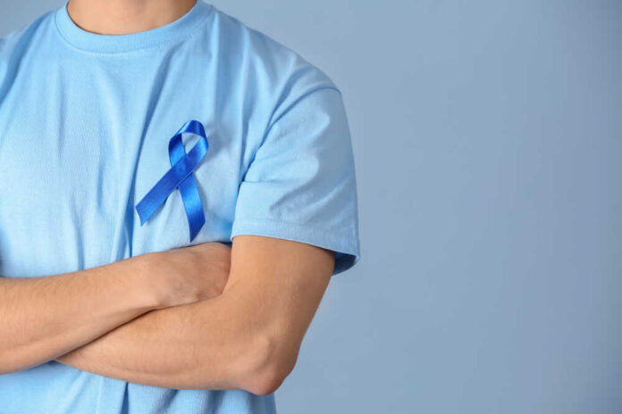 Young,Man,Wearing,T-shirt,With,Blue,Ribbon,On,Color,Background,