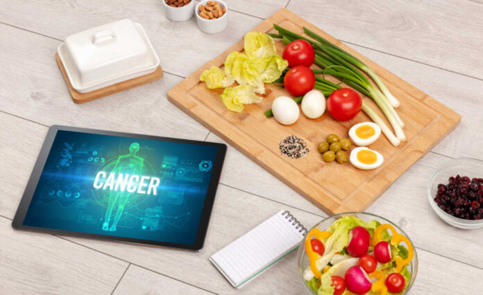 Cancer,Concept,In,Tablet,With,Fruits,,Top,View