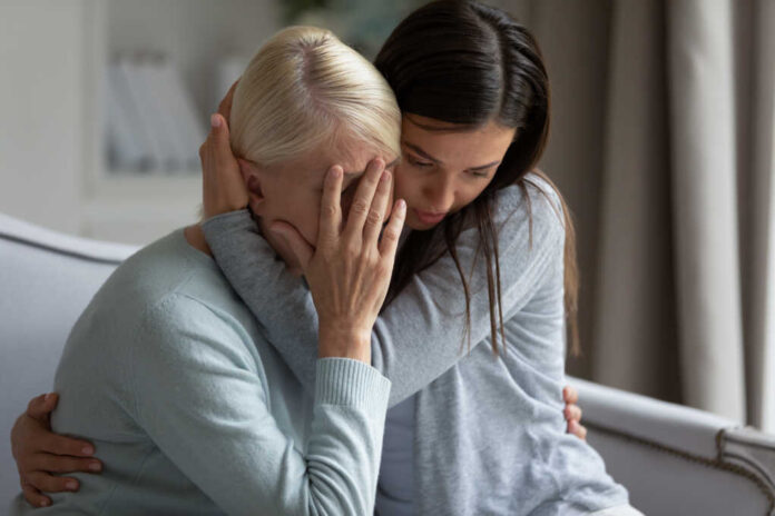Empathic,Young,Lady,Embracing,Soothing,Crying,Depressed,Elder,Mommy,,Sitting