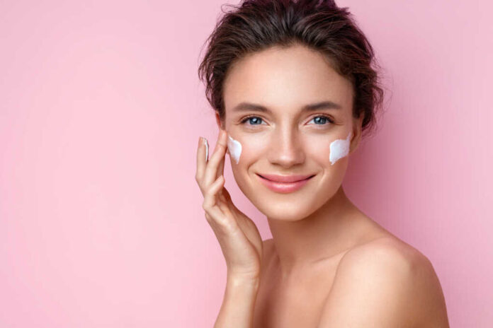 Beautiful,Woman,Applying,Moisturizer,Cream,On,Her,Face.,Photo,Of