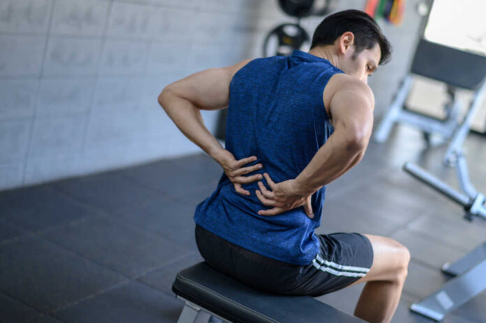 Young,Man,Having,Back,Pain,After,Workout,At,The,Gym.