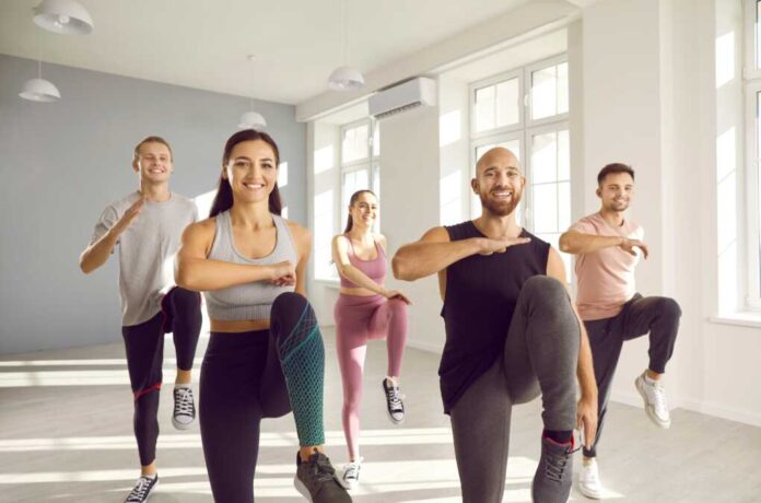 Group,Of,Young,Sporty,People,Doing,Exercises,Together,In,Bright