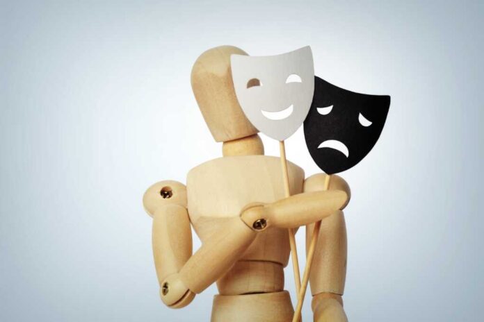 Wooden,Mannequin,With,Two,Masks,Showing,Different,Emotions,-,Concept