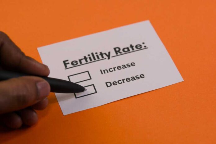 A,Hand,Holding,A,Pen,Is,Indicating,Options,About,Fertility