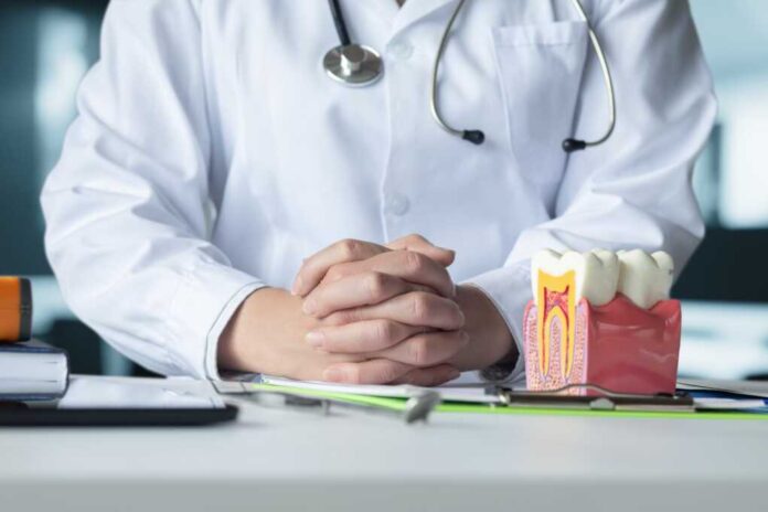 The,Doctor,And,Dentist,Sit,At,The,Table,During,A