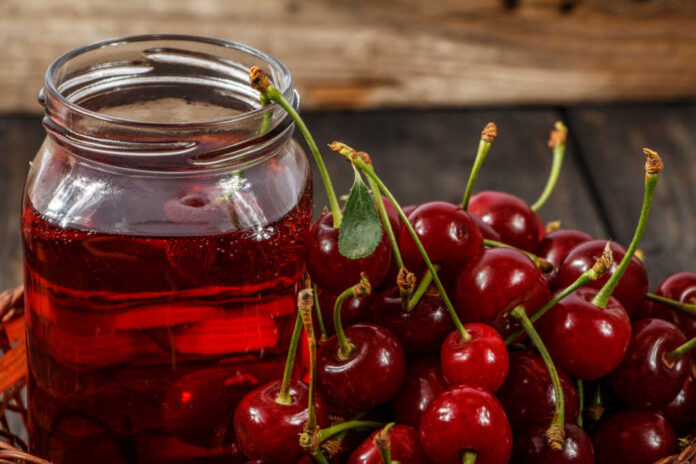 Cherry,Juice,And,Fresh,Cherries,On,A,Wooden,Background.,Fresh
