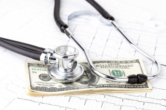 Stethoscope,Placing,On,Us,Dollar,Banknotes,On,Ecg,Background