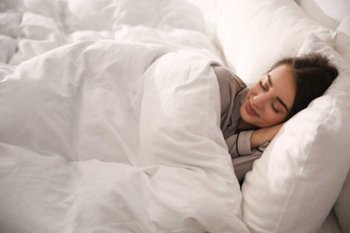 Beautiful,Young,Woman,Wrapped,With,Soft,Blanket,Sleeping,In,Bed