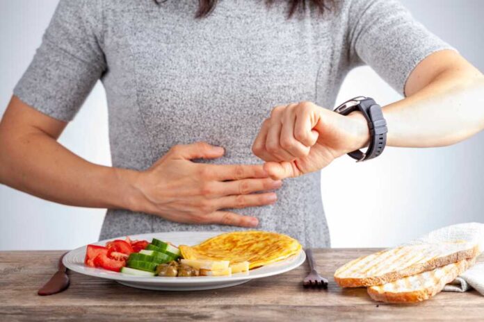 Intermittent,Fasting,Concept,With,A,Woman,Sitting,Hungry,In,Front