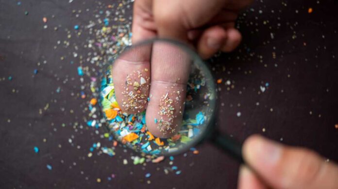 Close-up,Of,Micro,Plastic,Particles,On,The,Fingers,Under,A