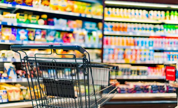 A,Shopping,Cart,By,A,Store,Shelf,In,A,Supermarket