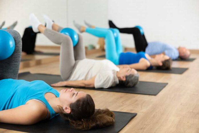 People,Of,Different,Ages,Pressing,Core,And,Clutching,Mini,Pilates