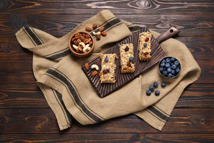 Tasty,Granola,Bars,And,Ingredients,On,Wooden,Table,,Flat,Lay