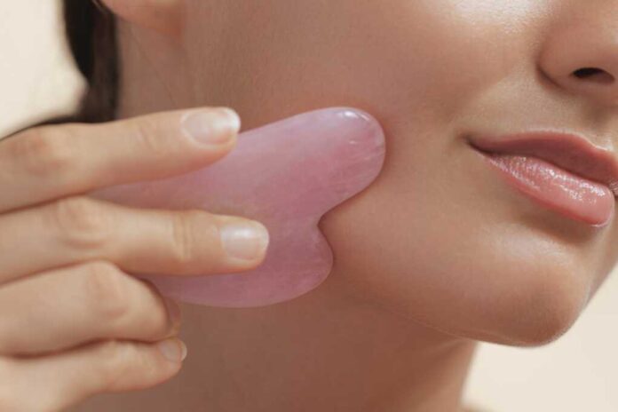 Woman,Beauty,And,Skincare,Concept,With,Self,Face,Massage,Gua