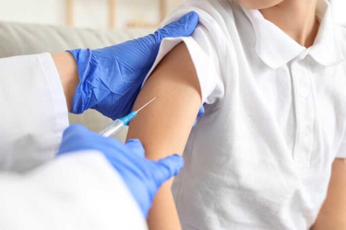 Ill,Little,Boy,With,Doctor,Vaccinating,At,Home,,Closeup
