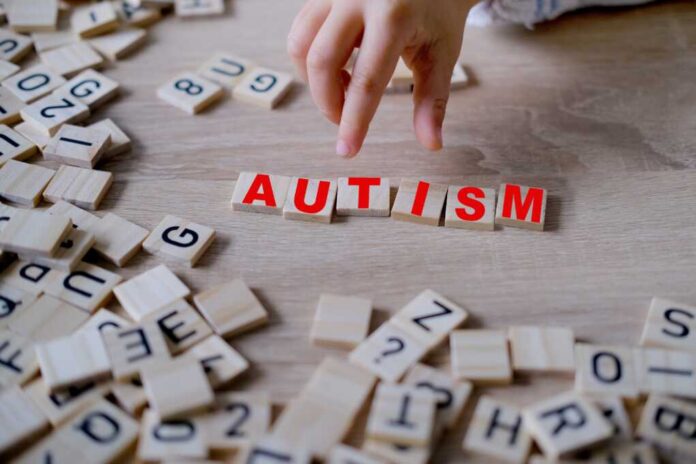 Child's,Hand,Complete,Word,"autism,",Symbolizing,Importance,Of,Early,Diagnosis