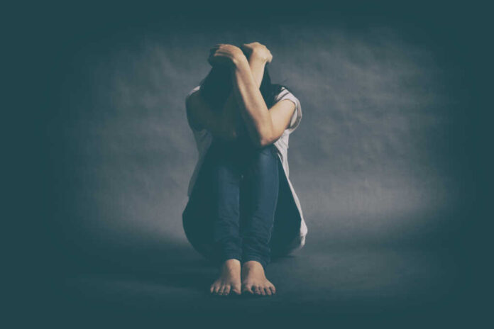 Teenager,Girl,With,Depression,Sitting,Alone,On,The,Floor,In